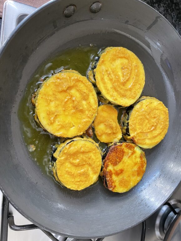 Spread the Brinjal and potato in fry pan.