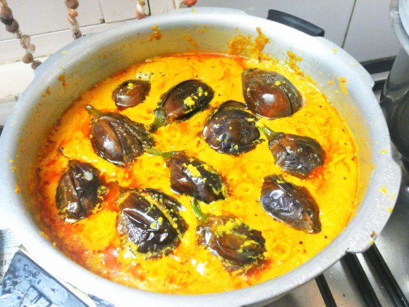  Add salt, fried brinjal and tomatoes