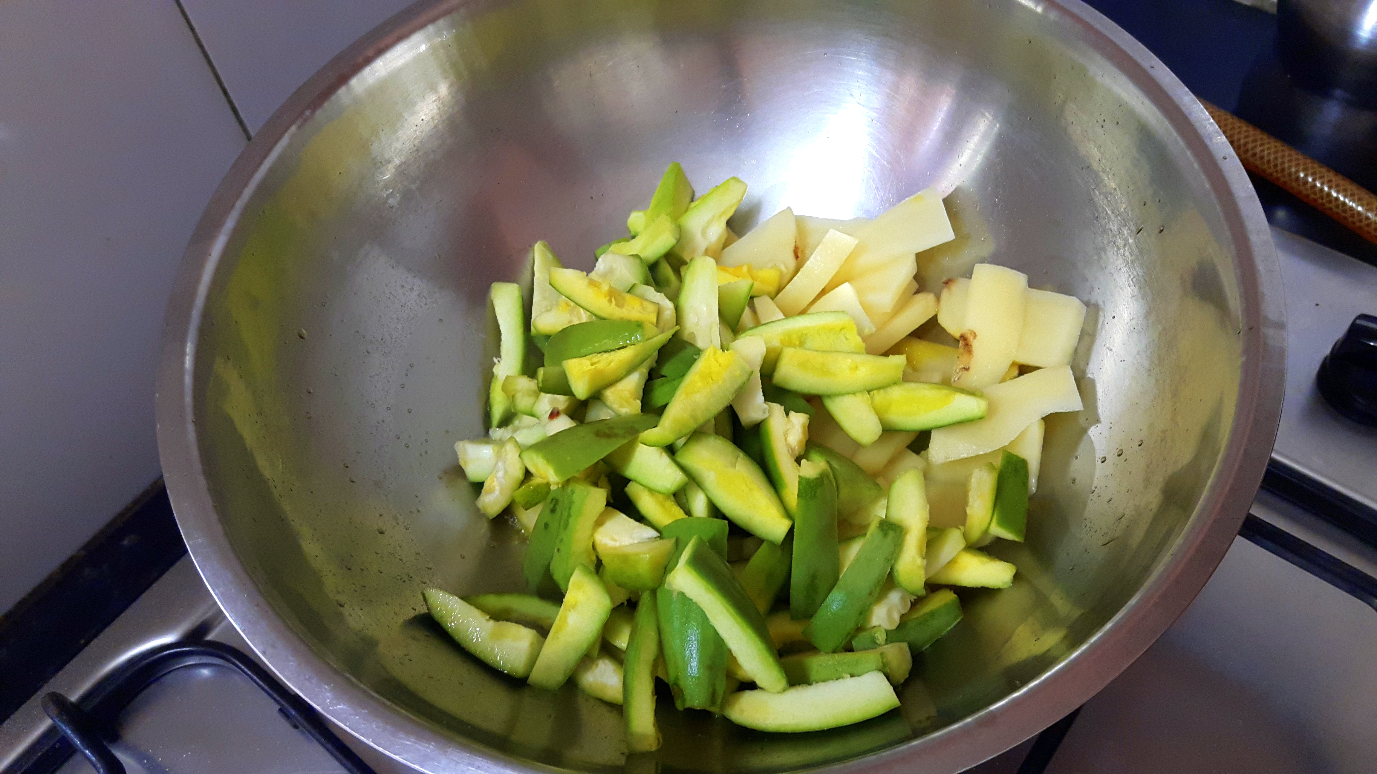Drop chopped potatoes and sliced Parwal