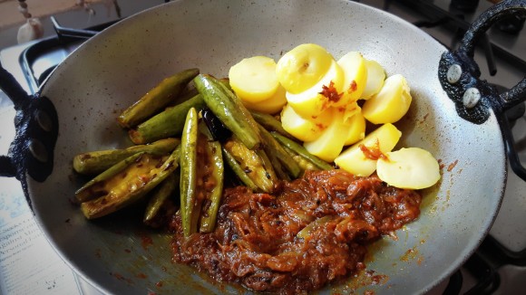 Add boiled and chopped potatoes and fried parawal