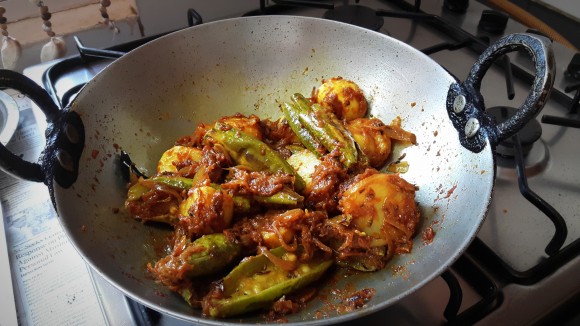 Add boiled and chopped potatoes and fried parawal