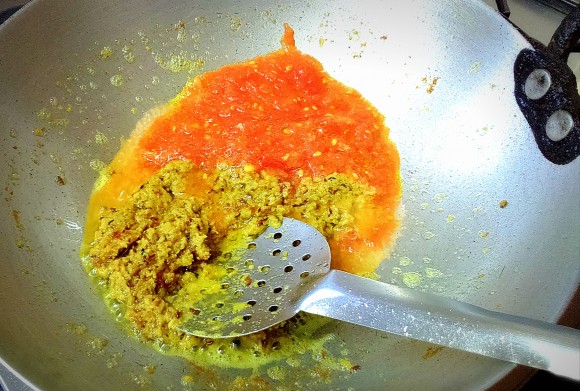 adding tomato paste