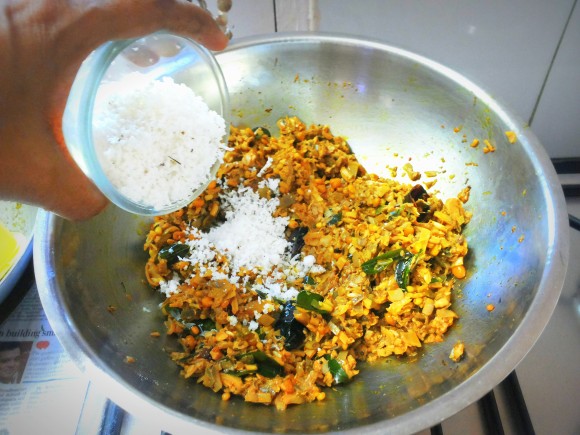 Adding fresh scrapped coconut