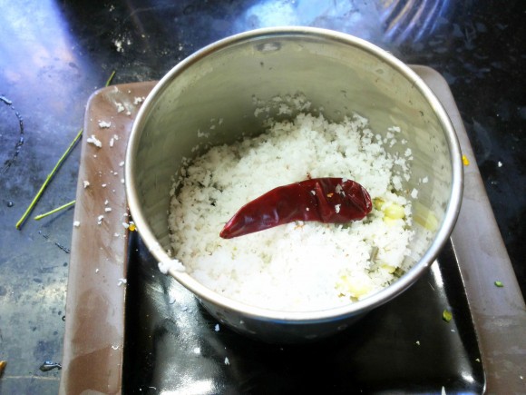 Roughly grind scrapped coconut, red chili and garlic