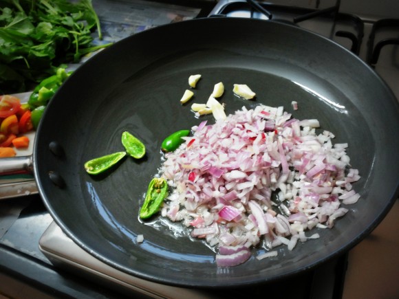 Add onion, green chilies and garlic 