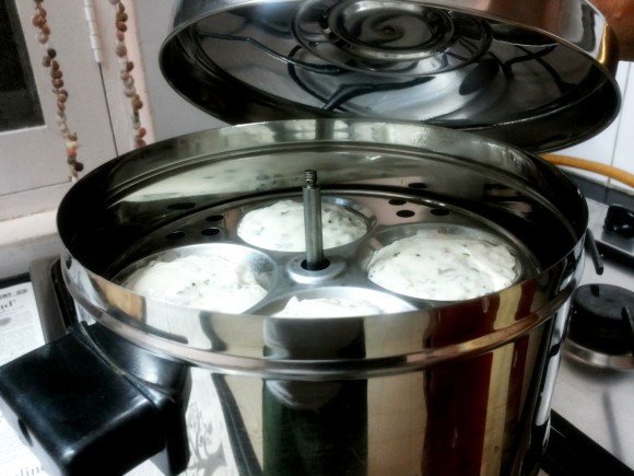 Place the idli stand into the idli cooker 
