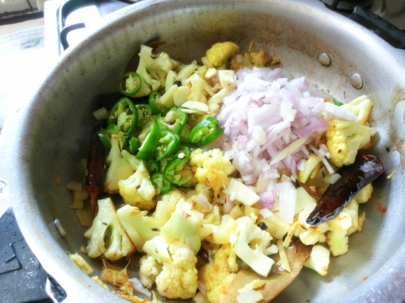 Add onion, green chili, garlic and ginger