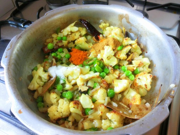 Add salt, turmeric powder and coriander powder