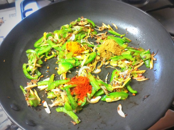 Add turmeric powder, coriander powder and chili powder 