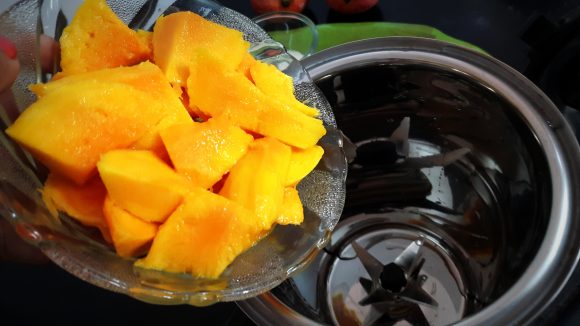 put chopped mango along with 100 ml milk and sugar
