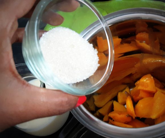 put chopped mango along with 100 ml milk and sugar