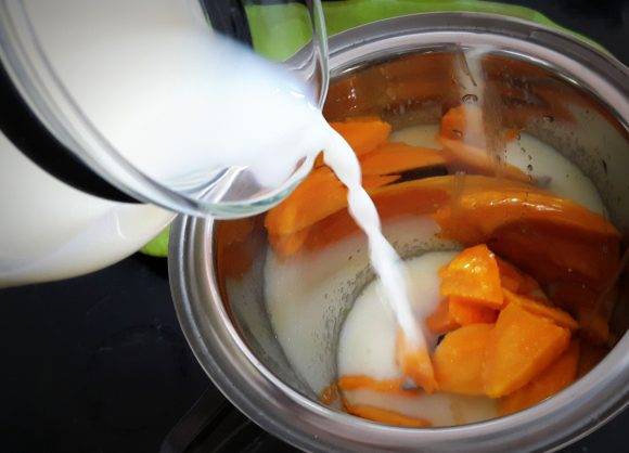 put chopped mango along with 100 ml milk and sugar
