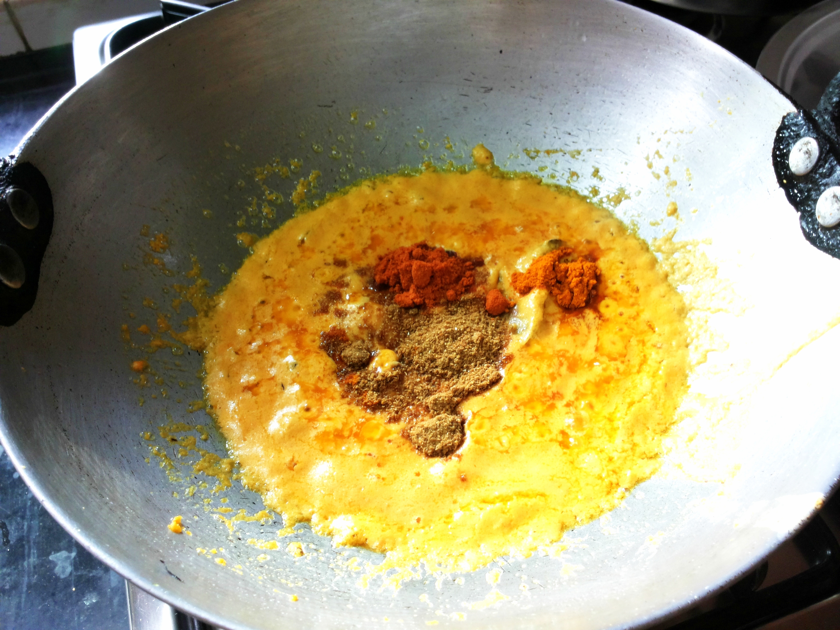 Add salt, turmeric powder, chili powder, and coriander powder
