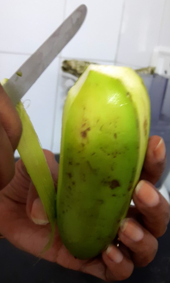 Discard the both ends and upper layer of raw banana