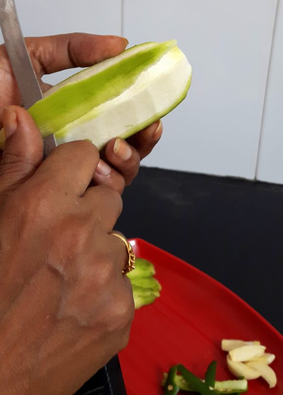 peel off the skin of raw banana thickly