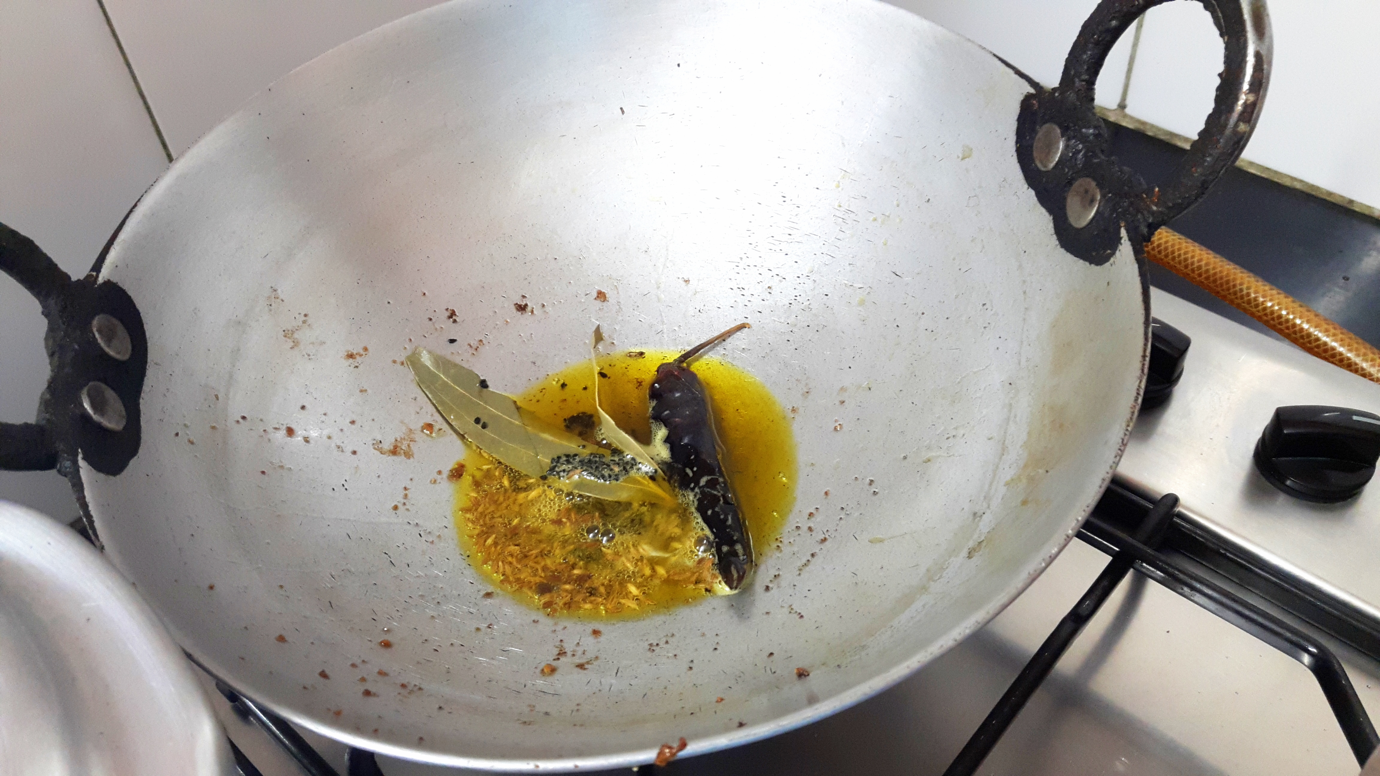 add bay leaf, cumin seed, Kalonji and red chili