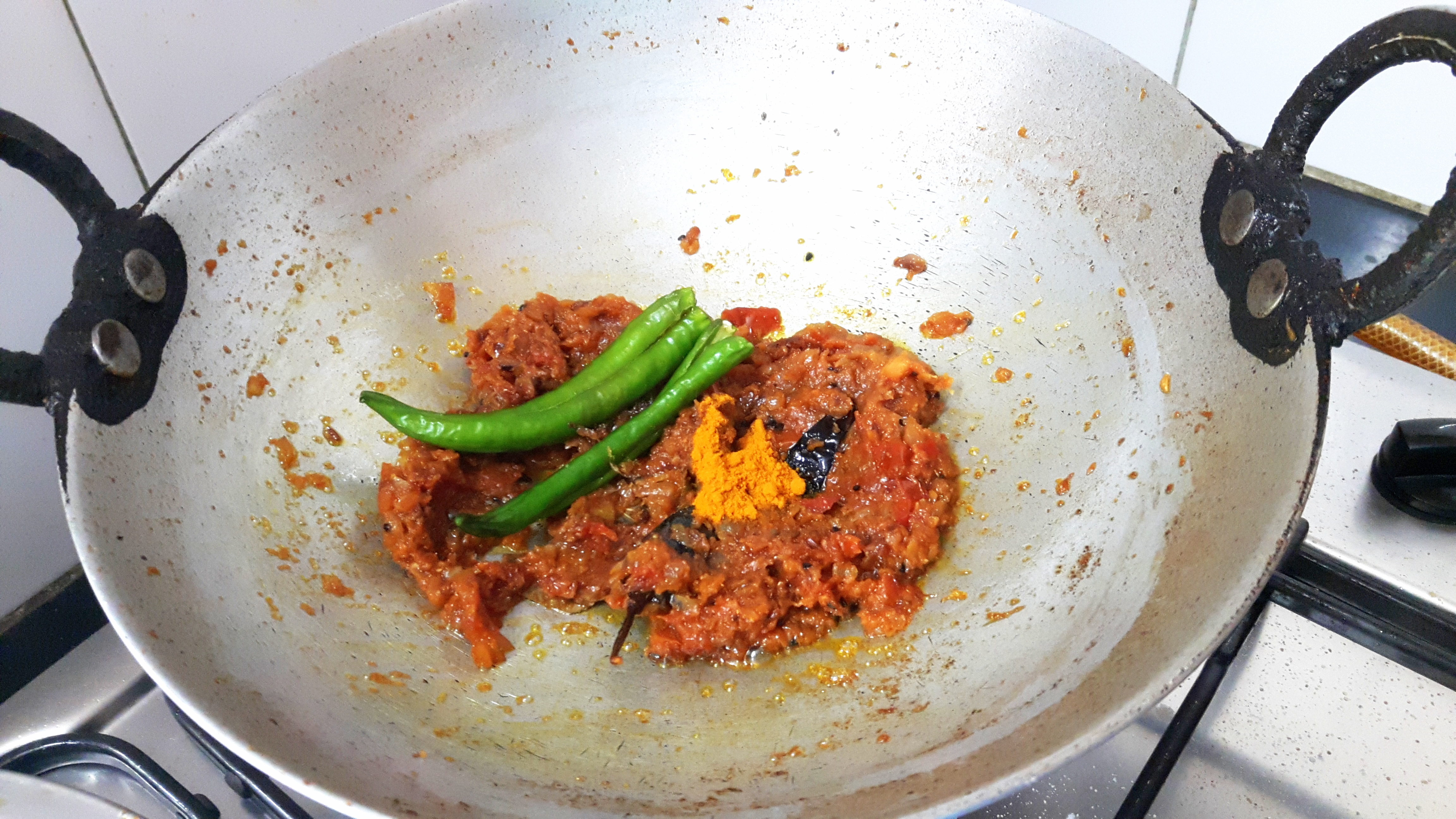 add slit green chili and turmeric powder