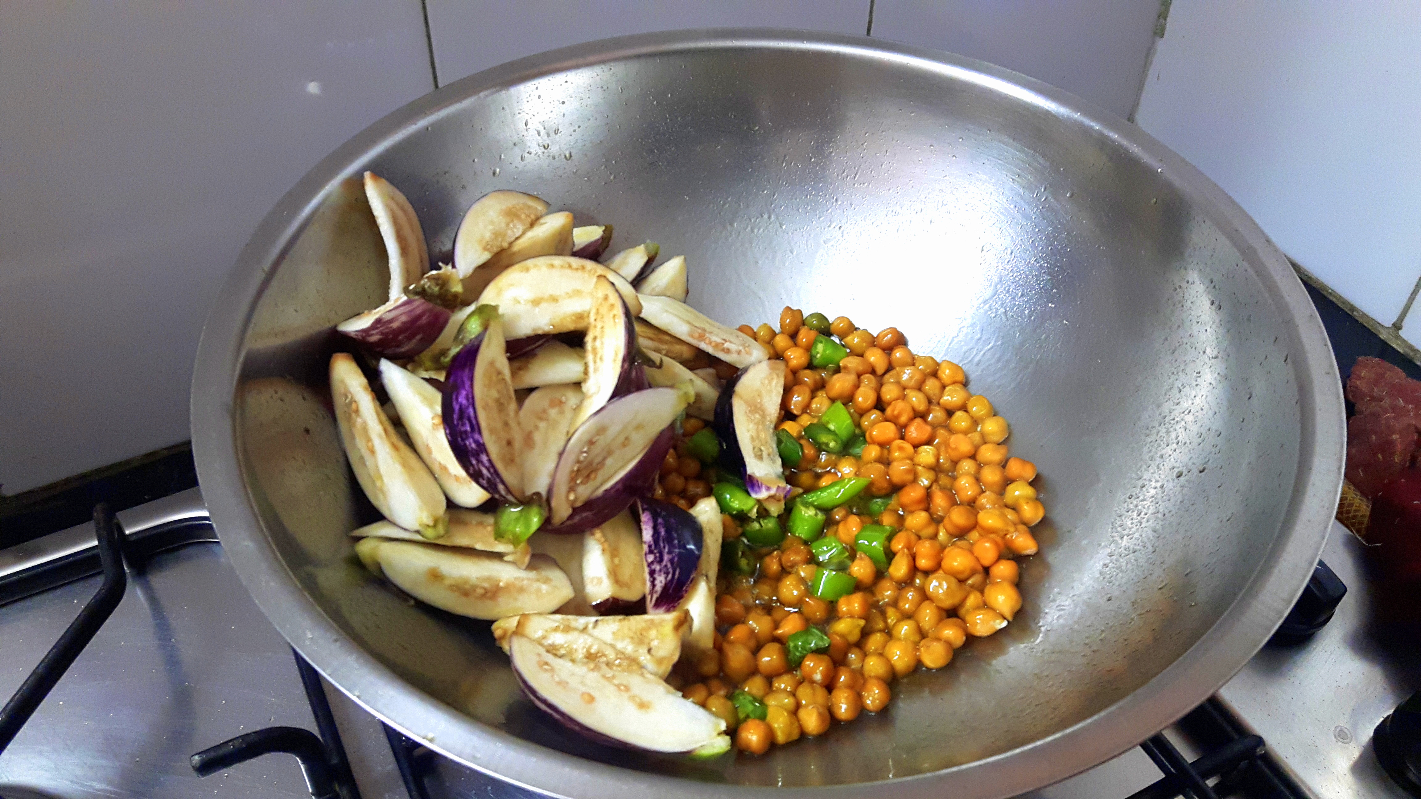 Add chopped green chili, chana and brinjal