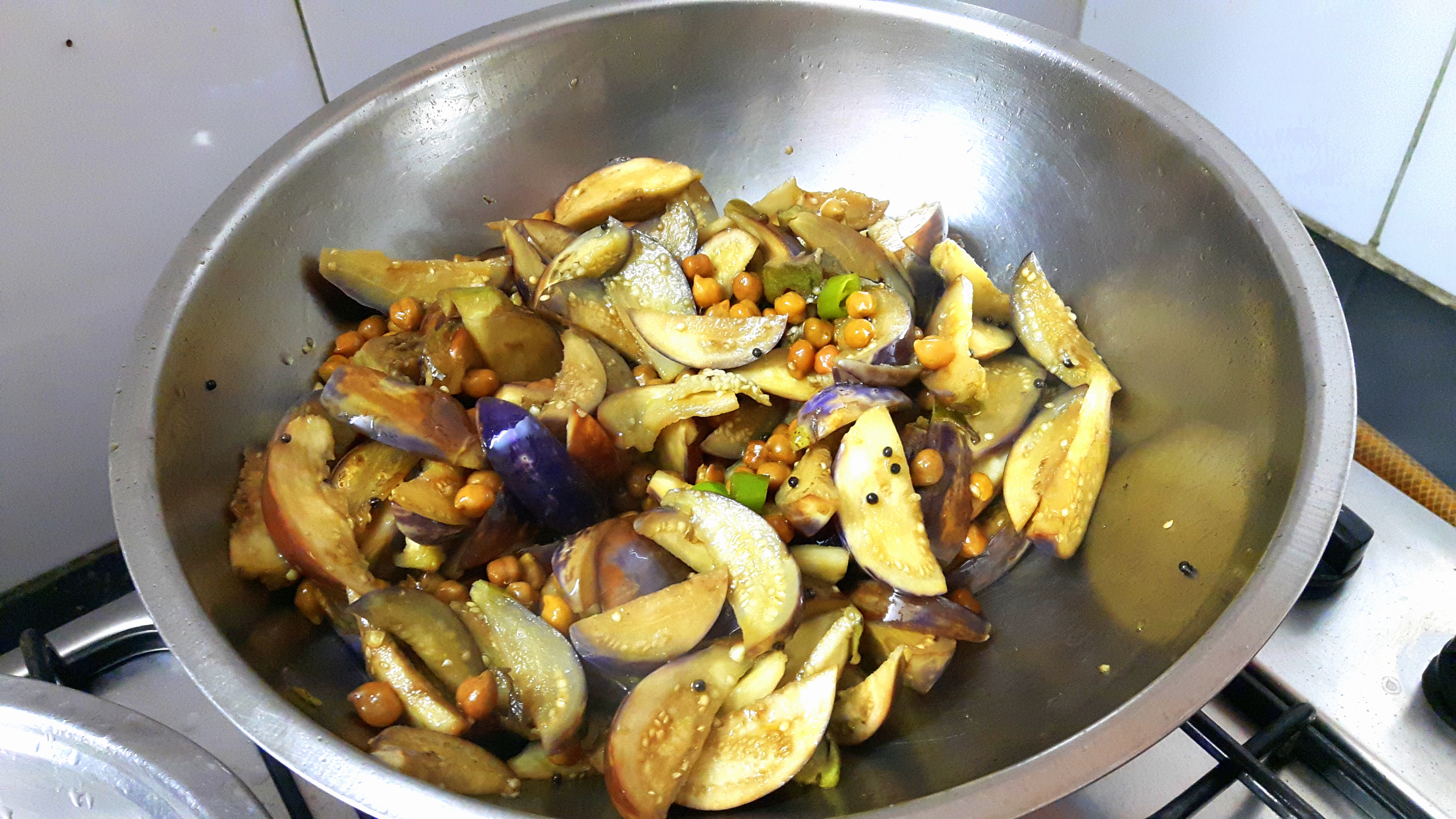 Add chopped green chili, chana and brinjal