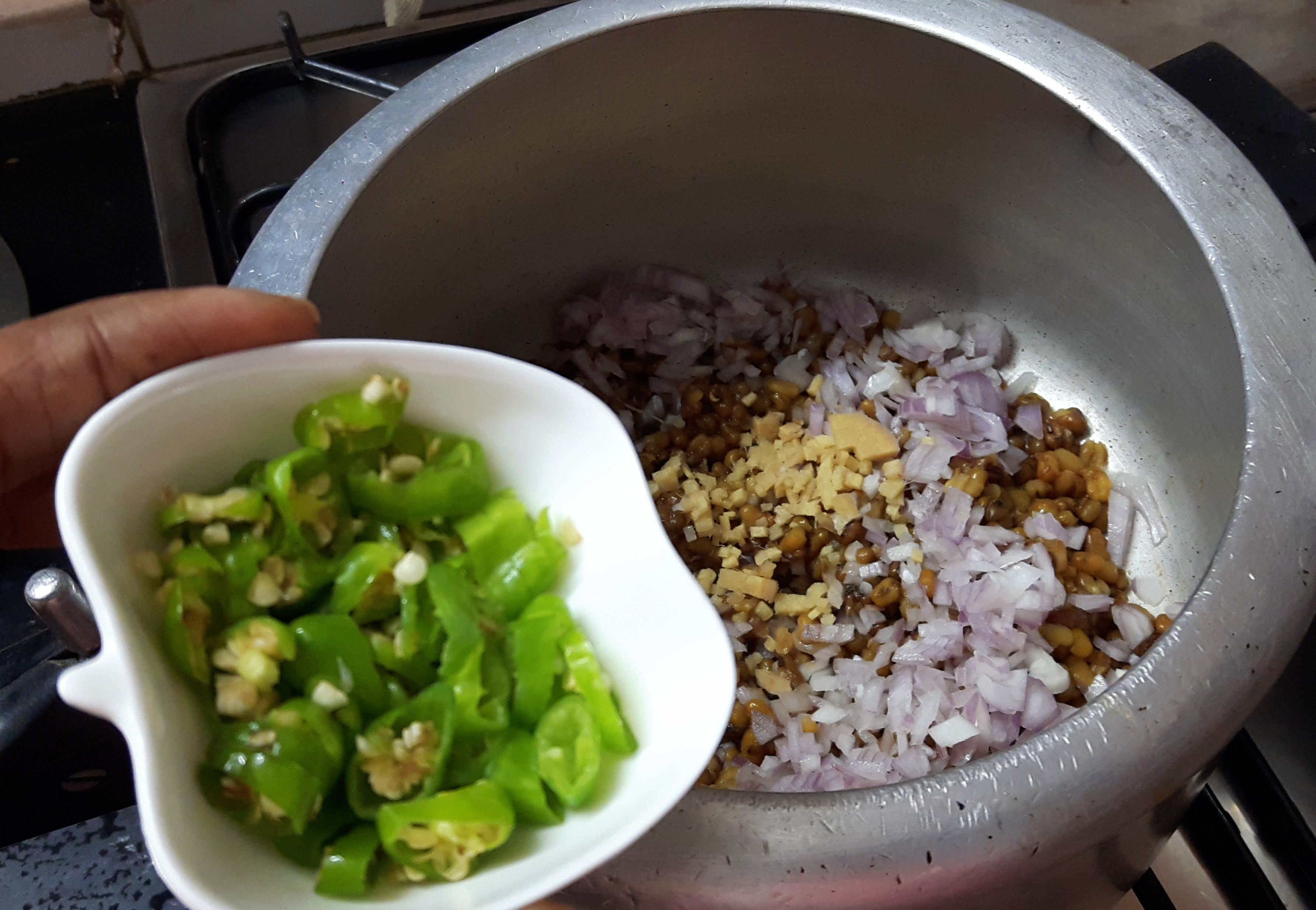 Add chopped onion, green chili, ginger and mustard oil
