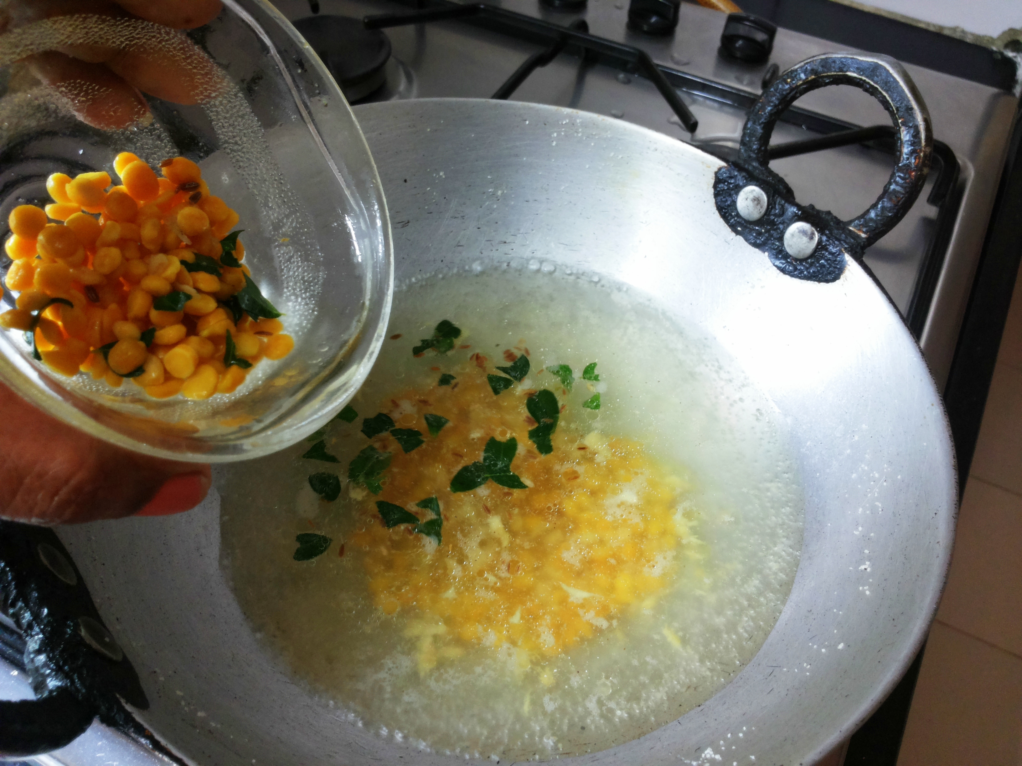 Add salt, grated ginger, curry leaves and chana dal