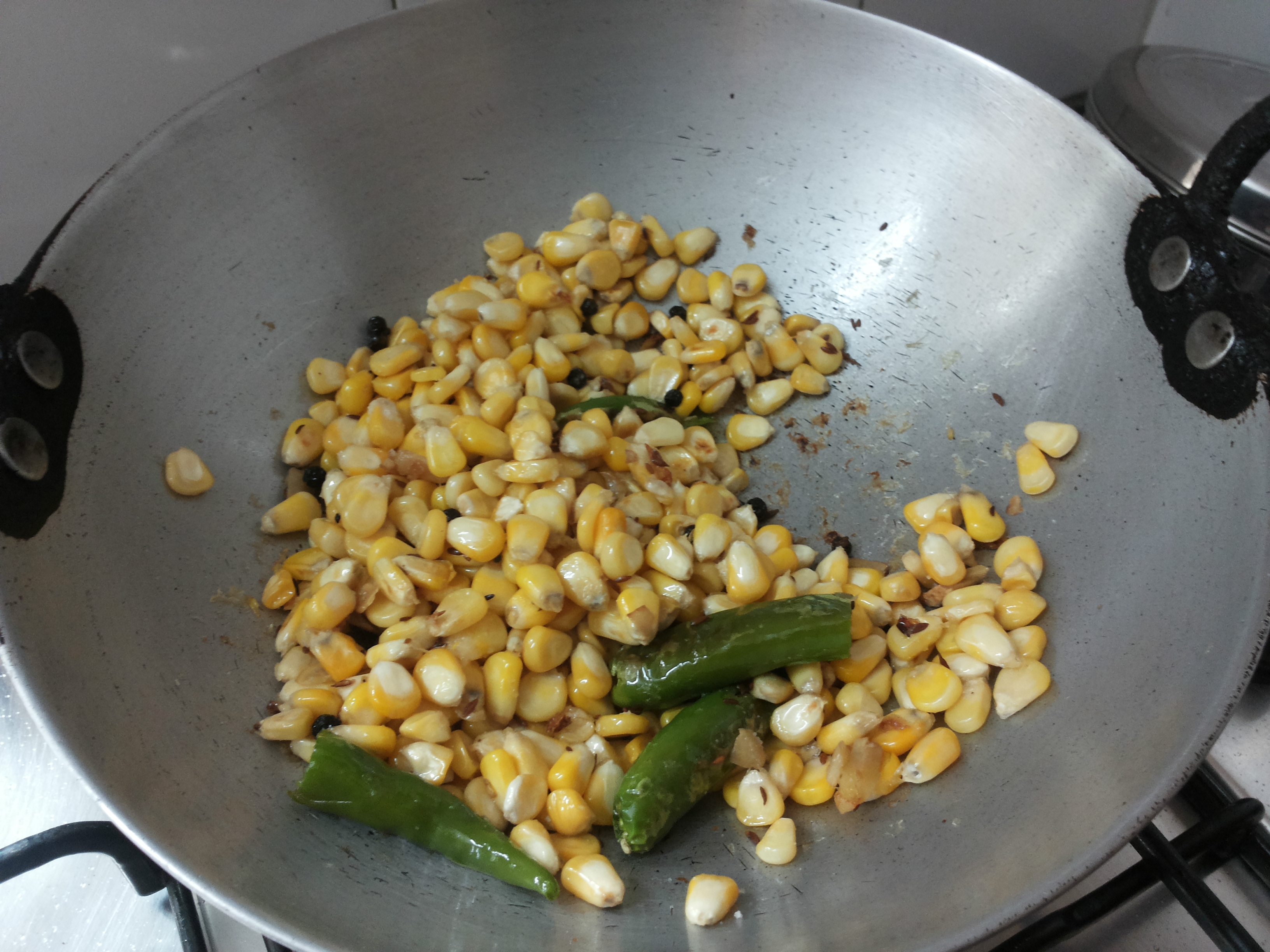 add asafoetida, corn and salt