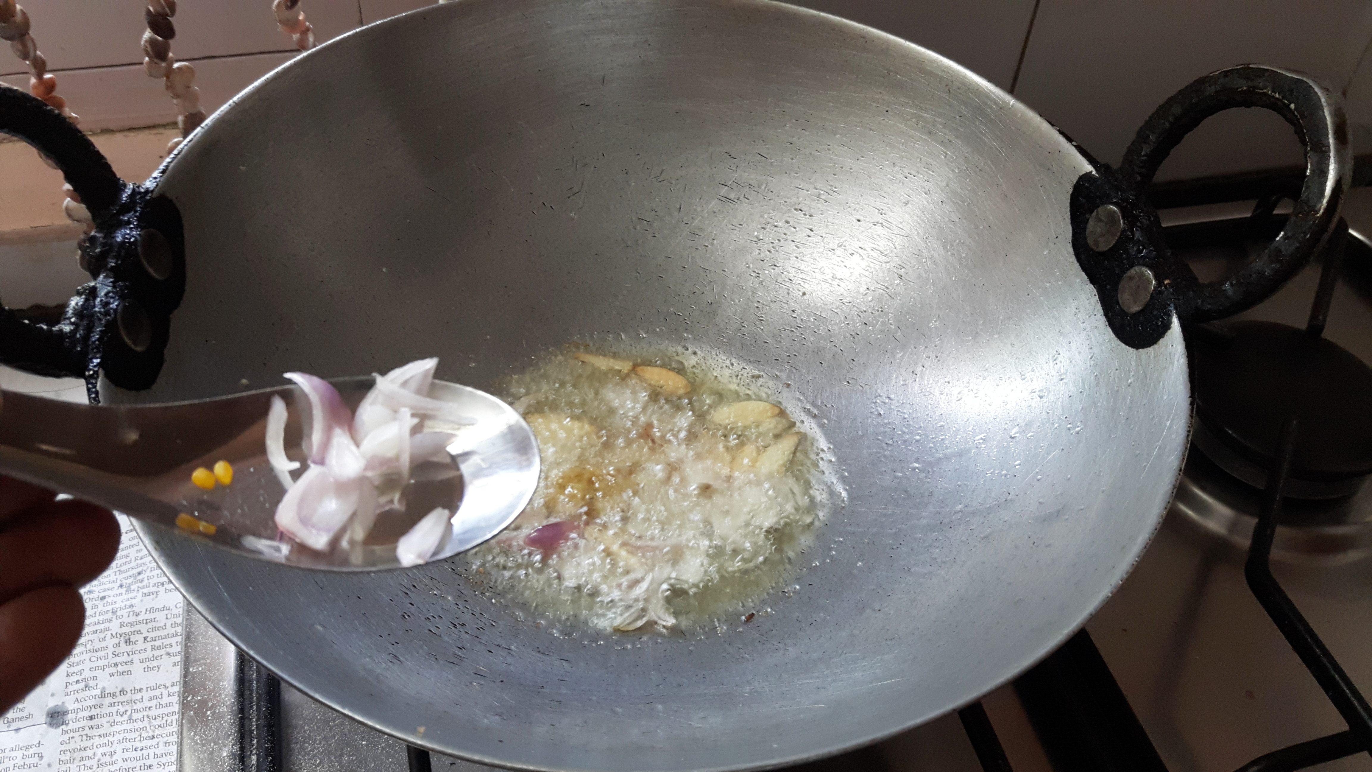 add split black gram, fenugreek seed, mustard seed, red chili, garlic, curry leaves and onion.
