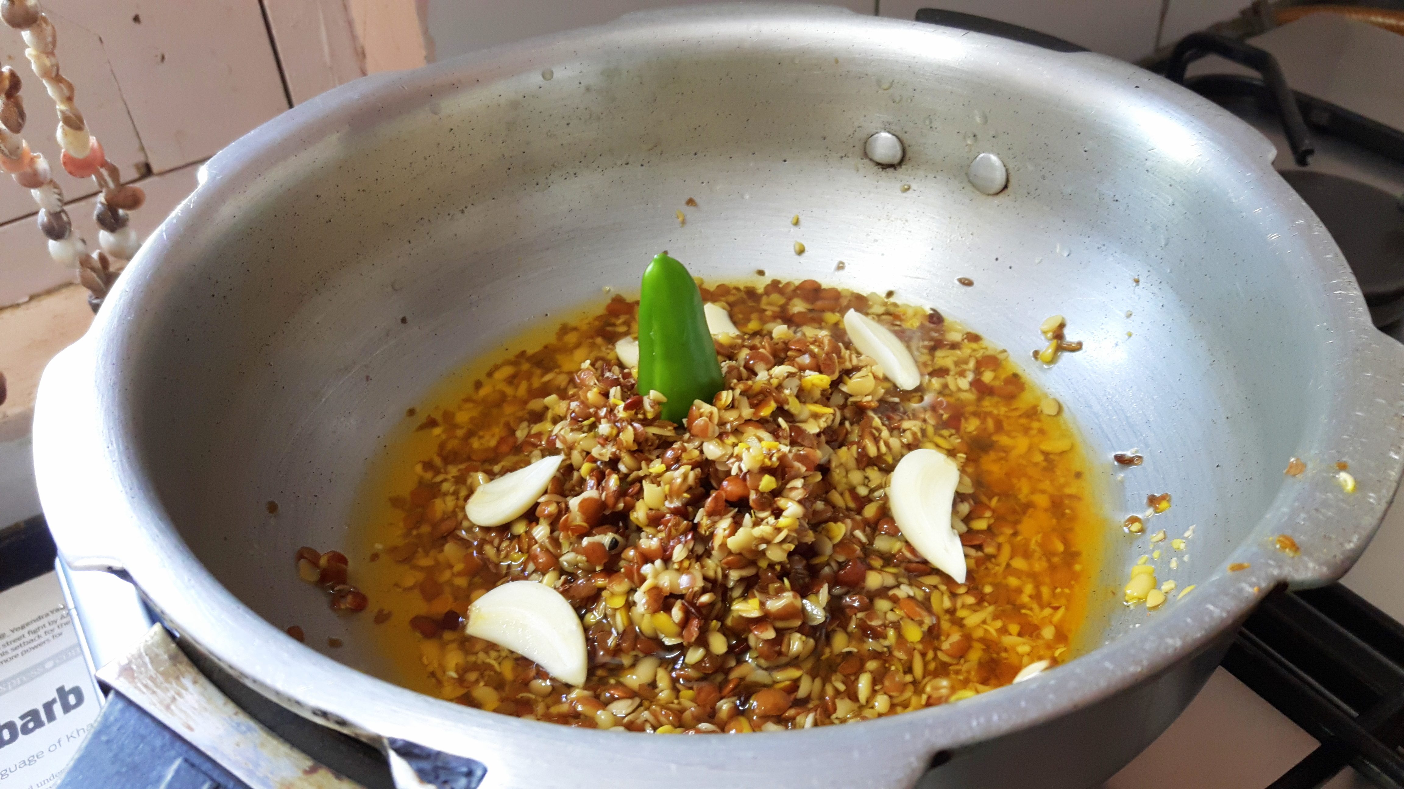 Boil prepared kulthi along with garlic, green chili, ginger, salt, and turmeric powder