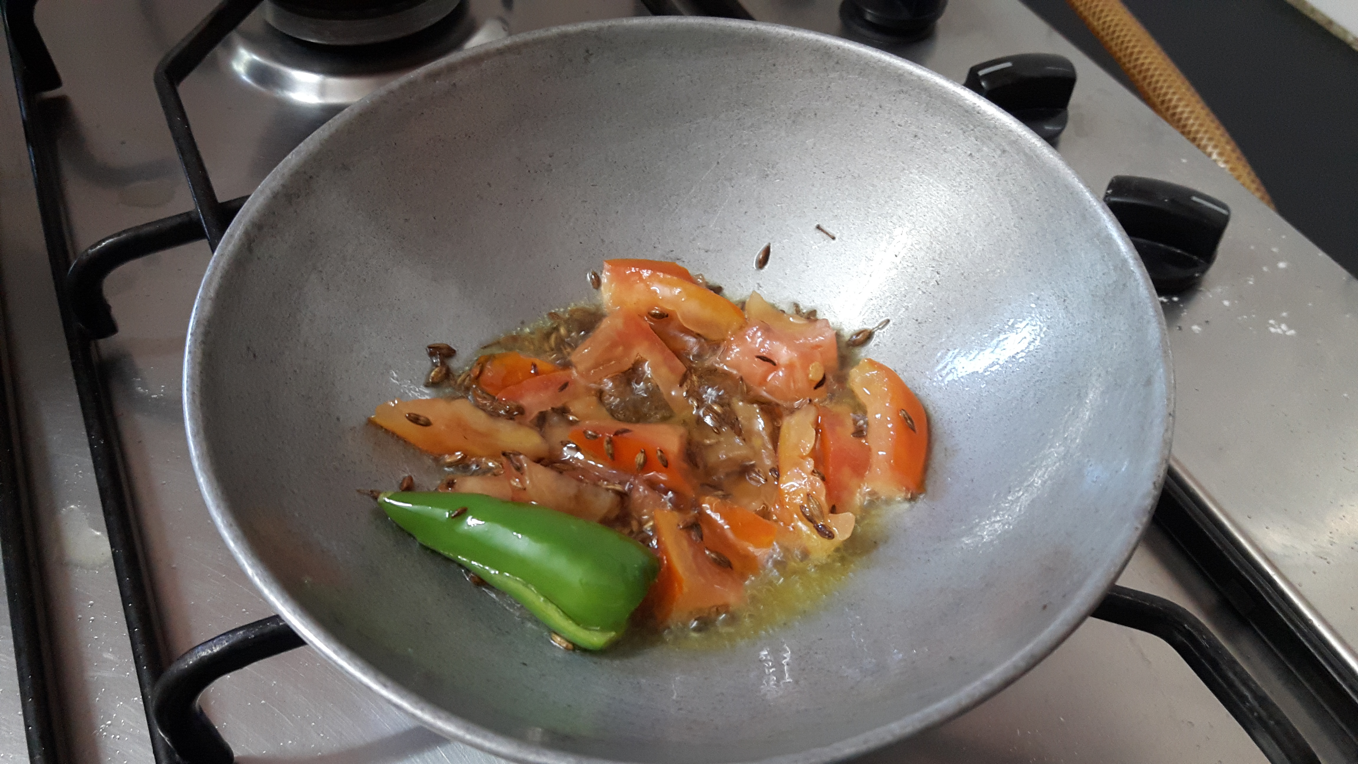 add slit green chili and chopped tomato