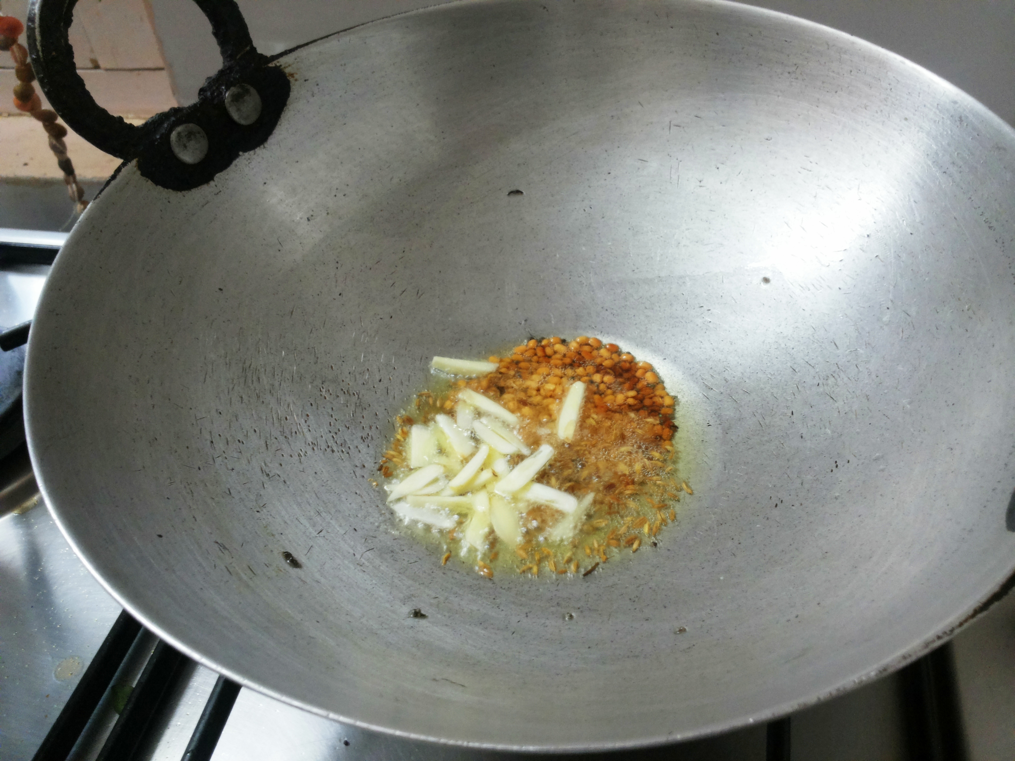 Add turmeric powder and garlic