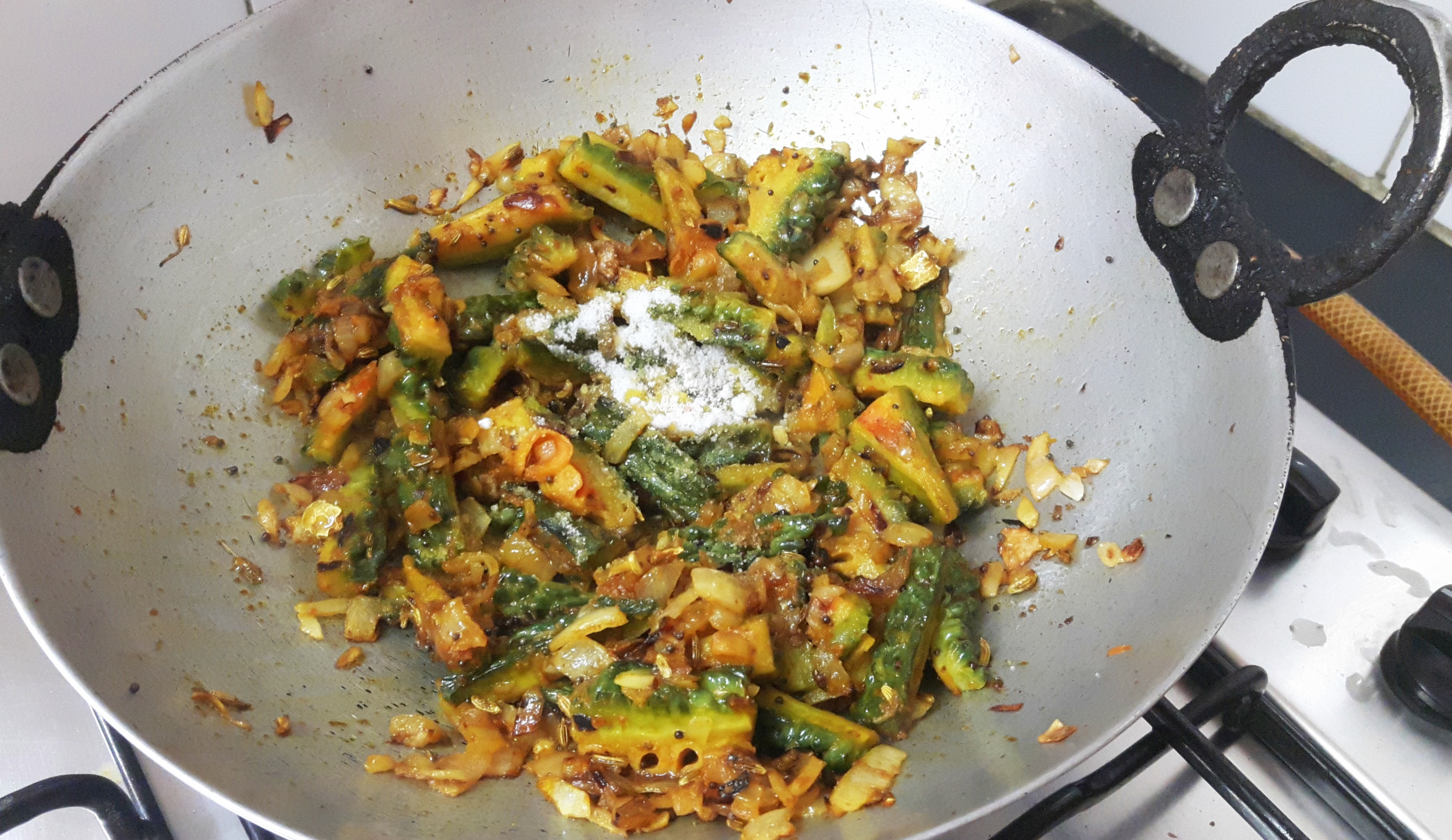 add coriander powder, turmeric powder, salt, peanut, and sesame seed powder
