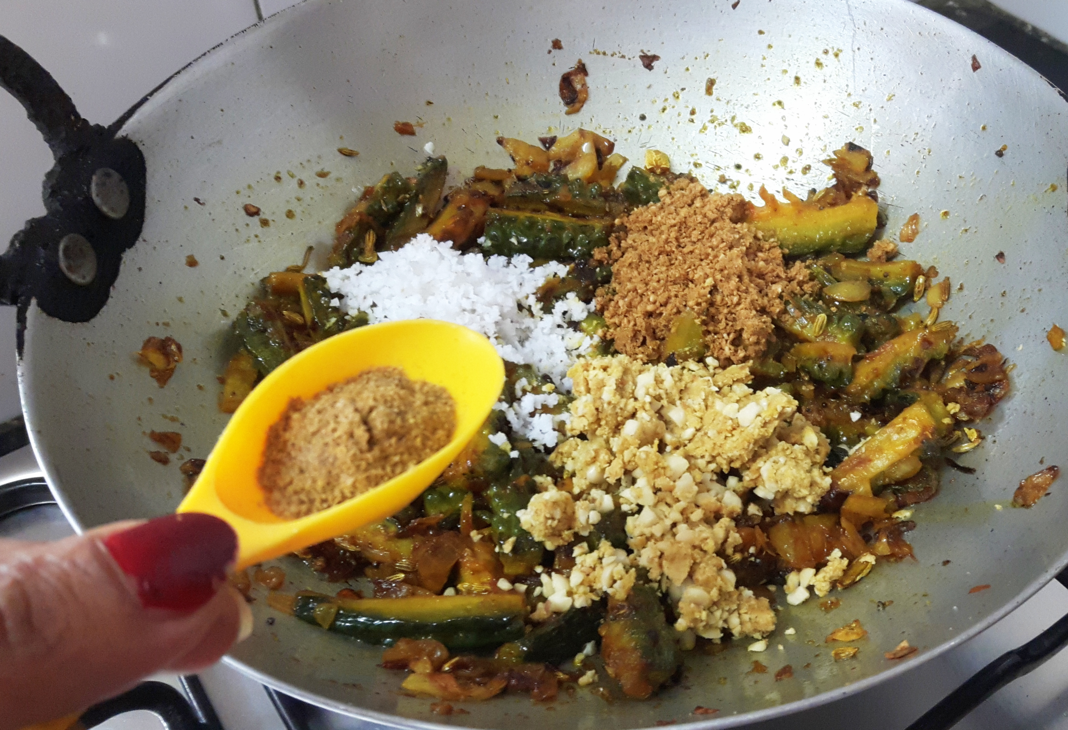 add coriander powder, turmeric powder, salt, peanut, and sesame seed powder