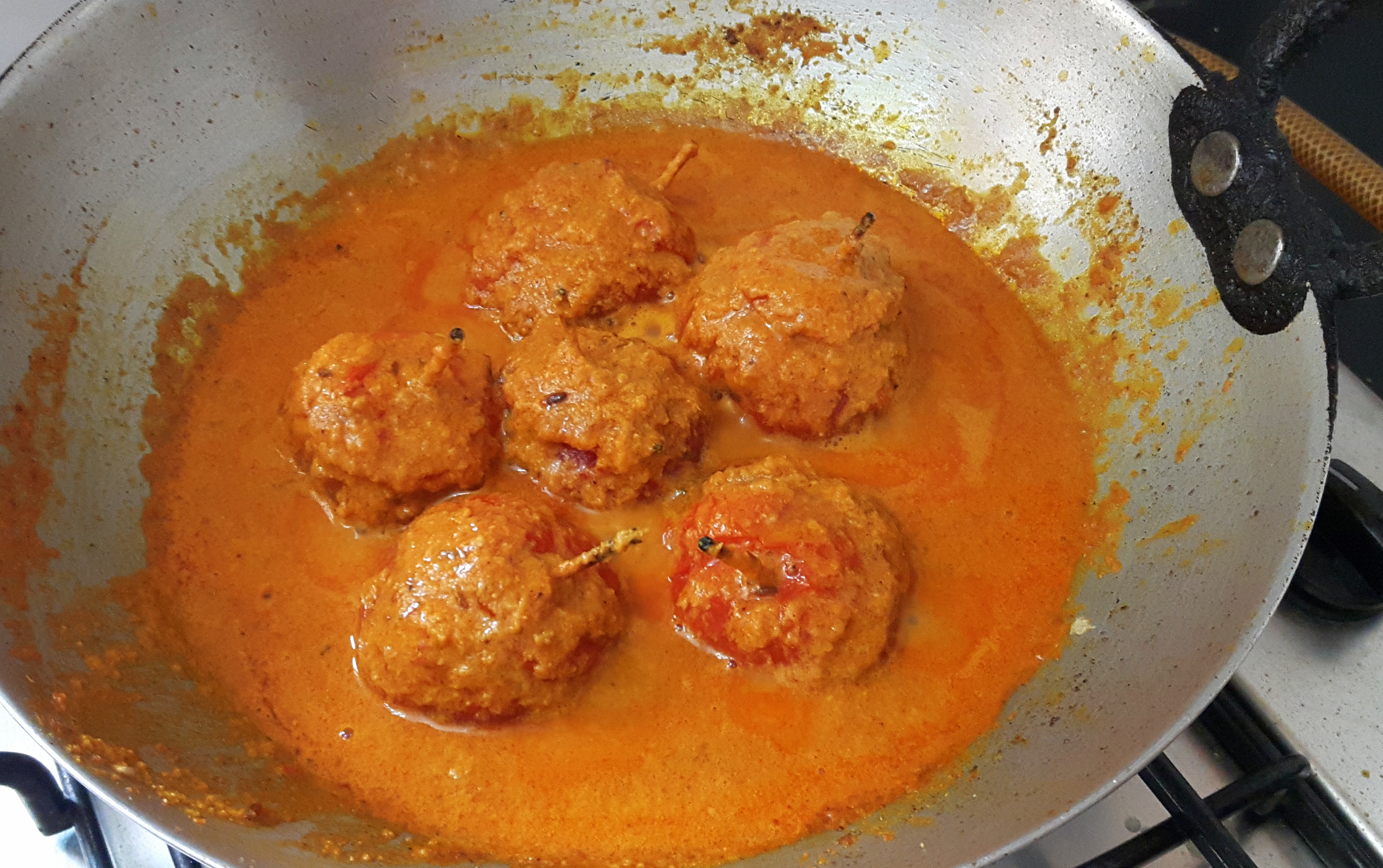 Add Garam masala powder and stuffed tomatoes