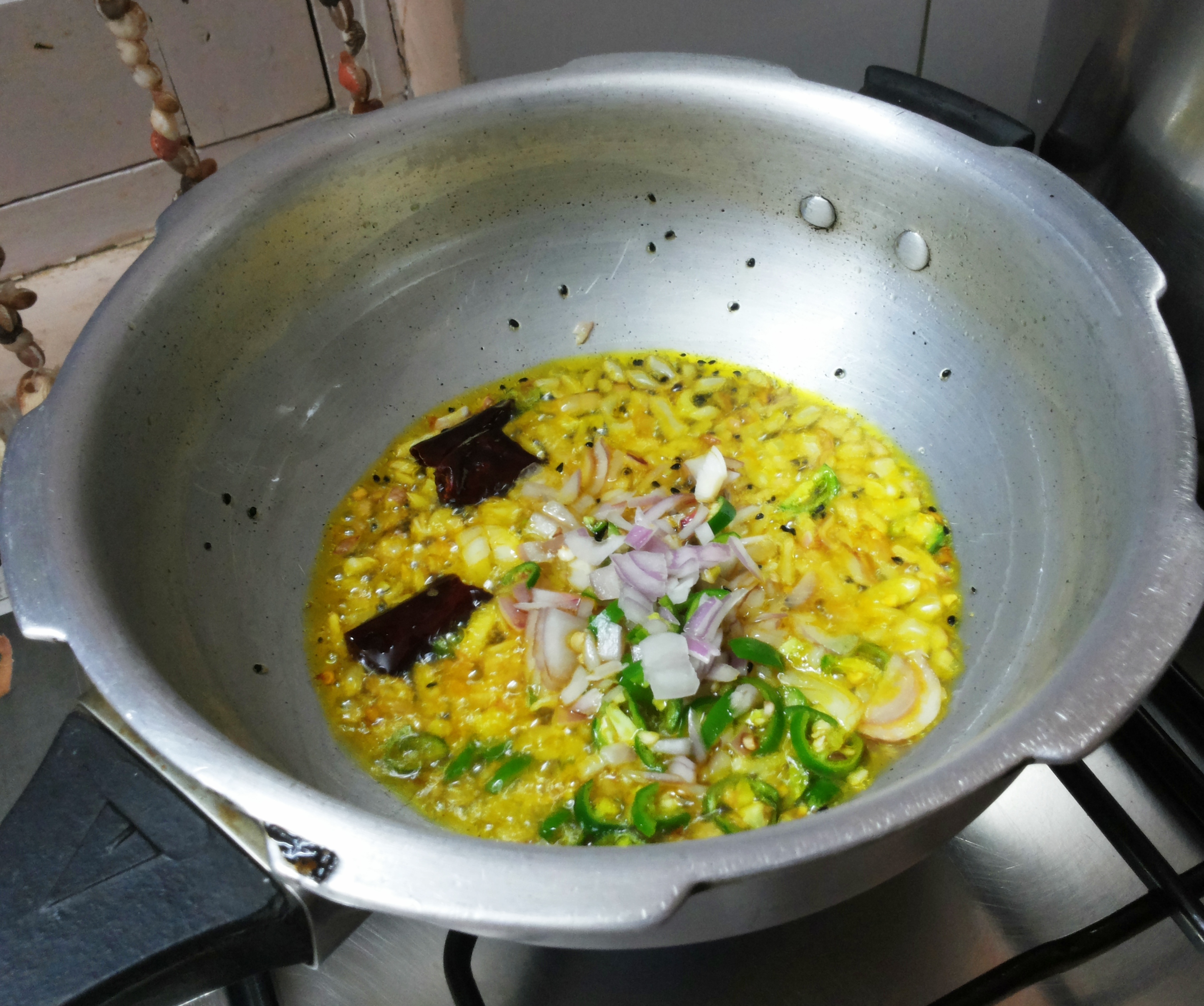 Add chopped onion and green chili