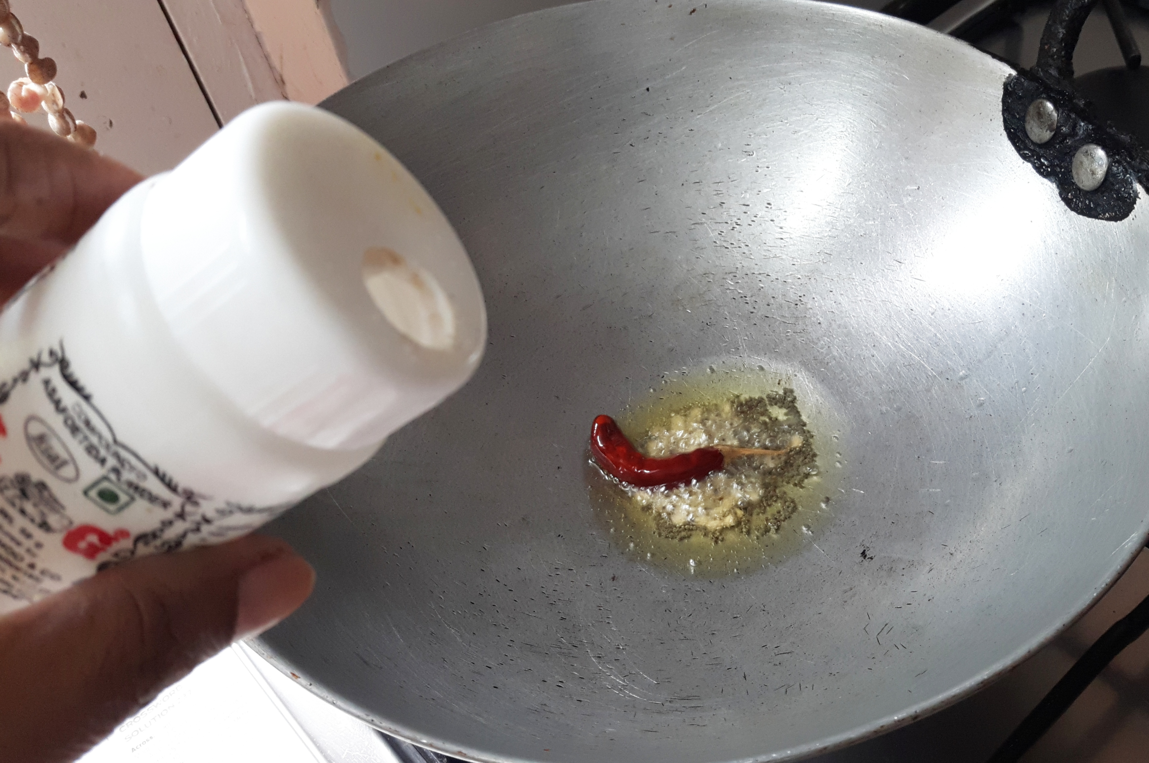 add mustard seeds, urad dal, dry red chili, and asafoetida