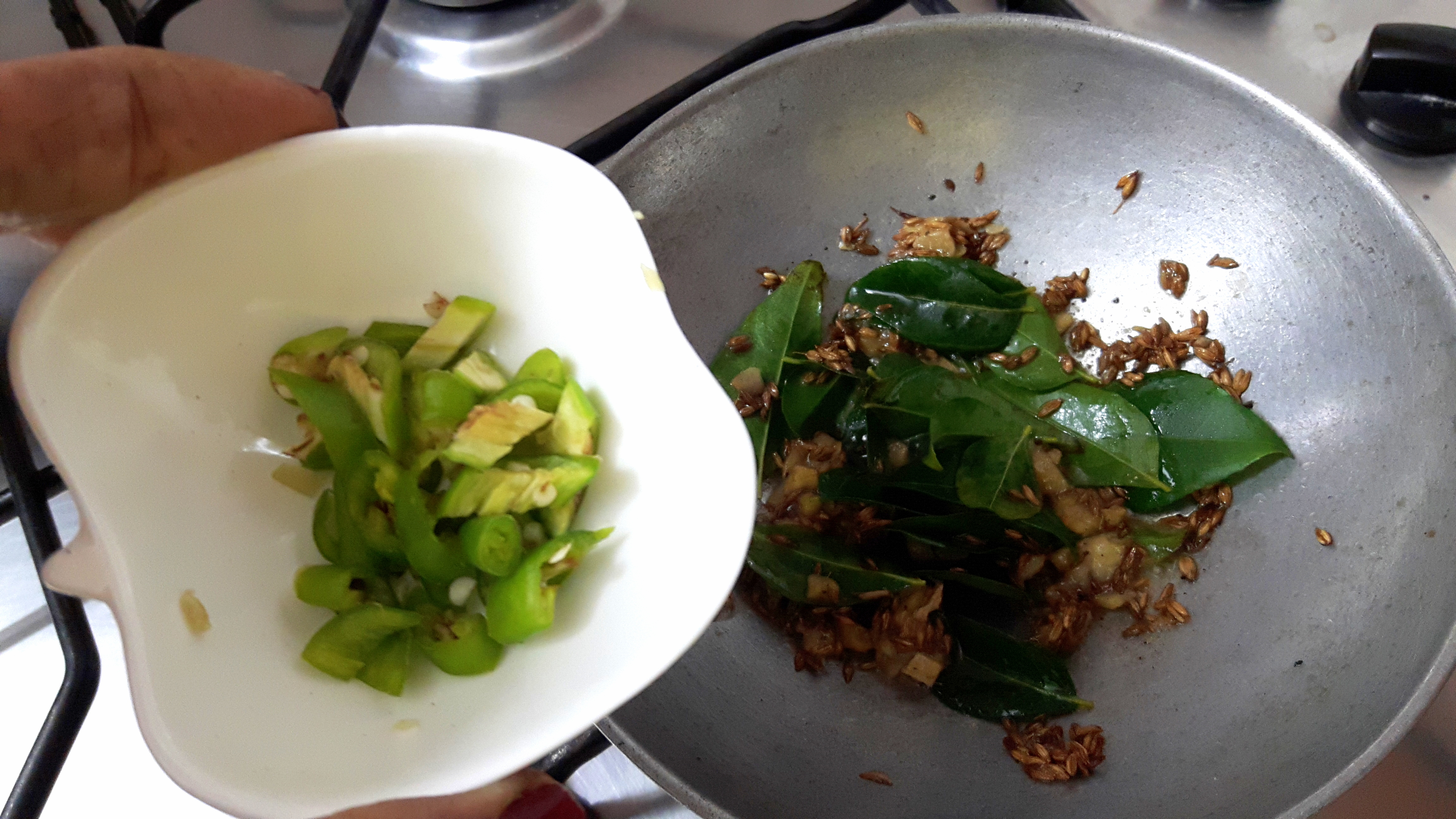 add chopped ginger, asafoetida, curry leaves and green chili