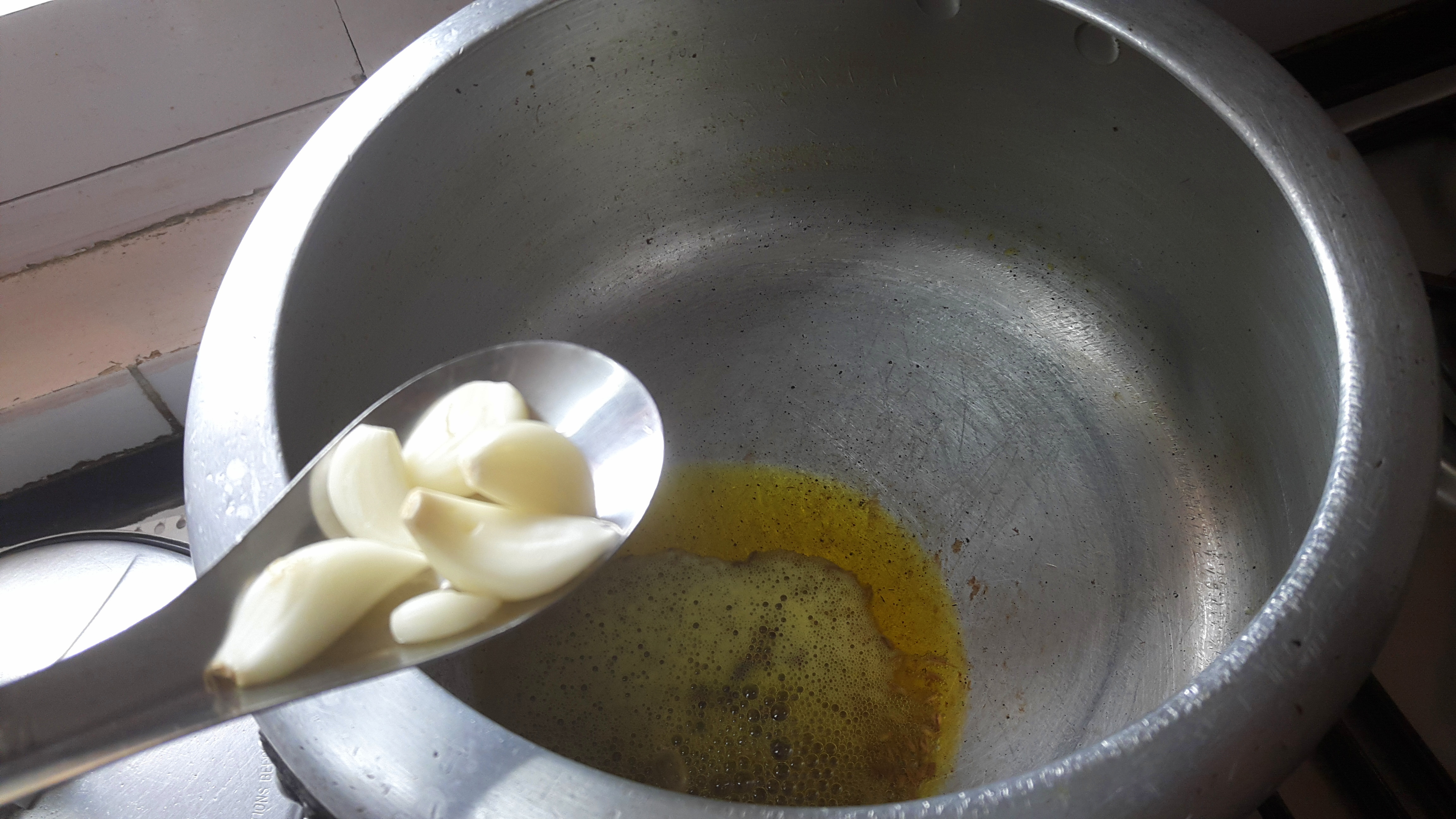 Put garlic, bay leaf, cumin seed and cloves