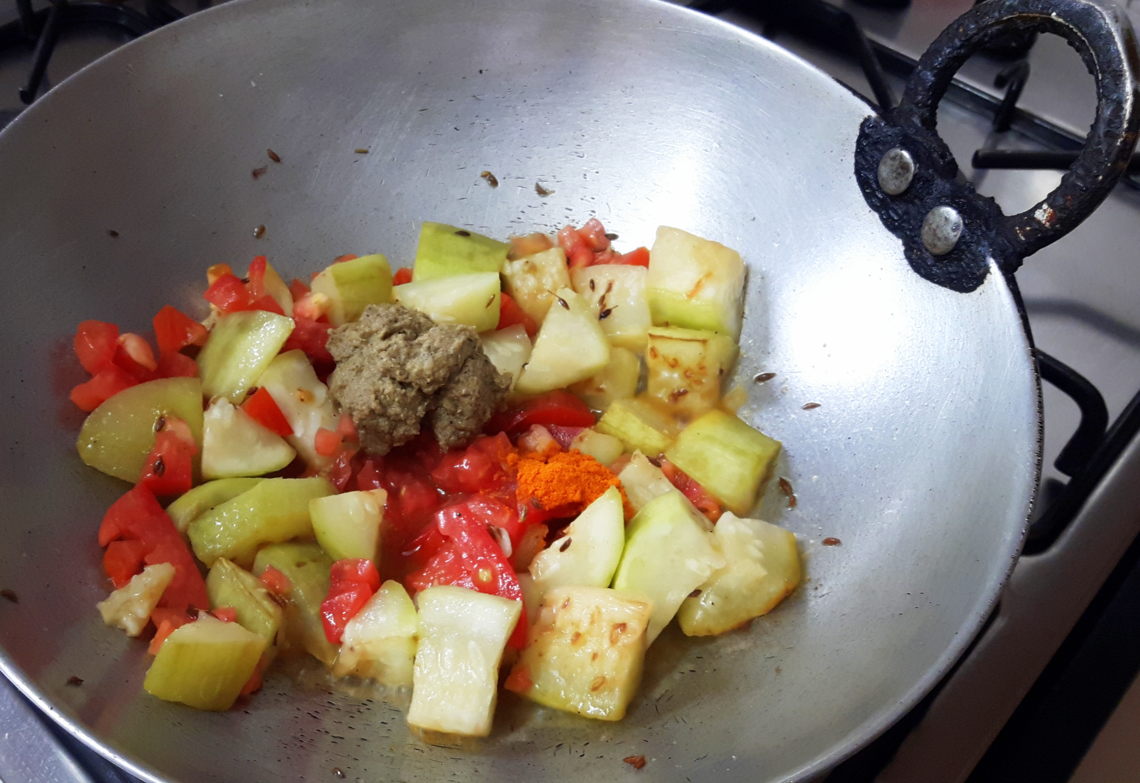 add chopped tomato and grounded paste