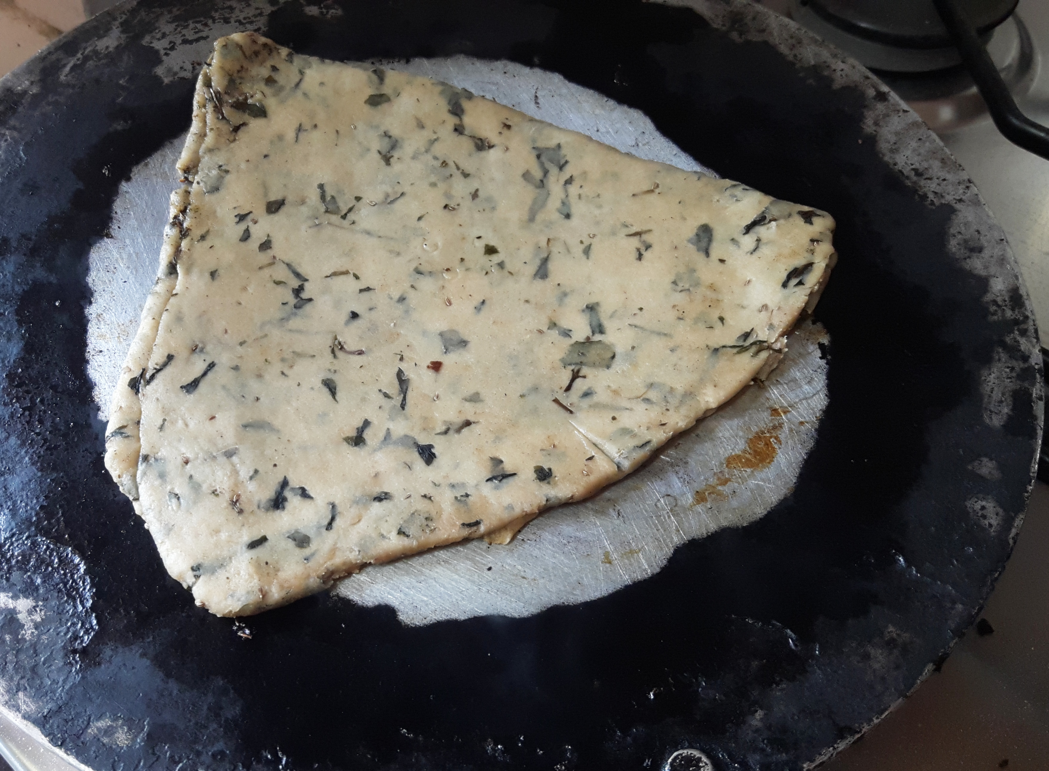 Place the rolled paratha