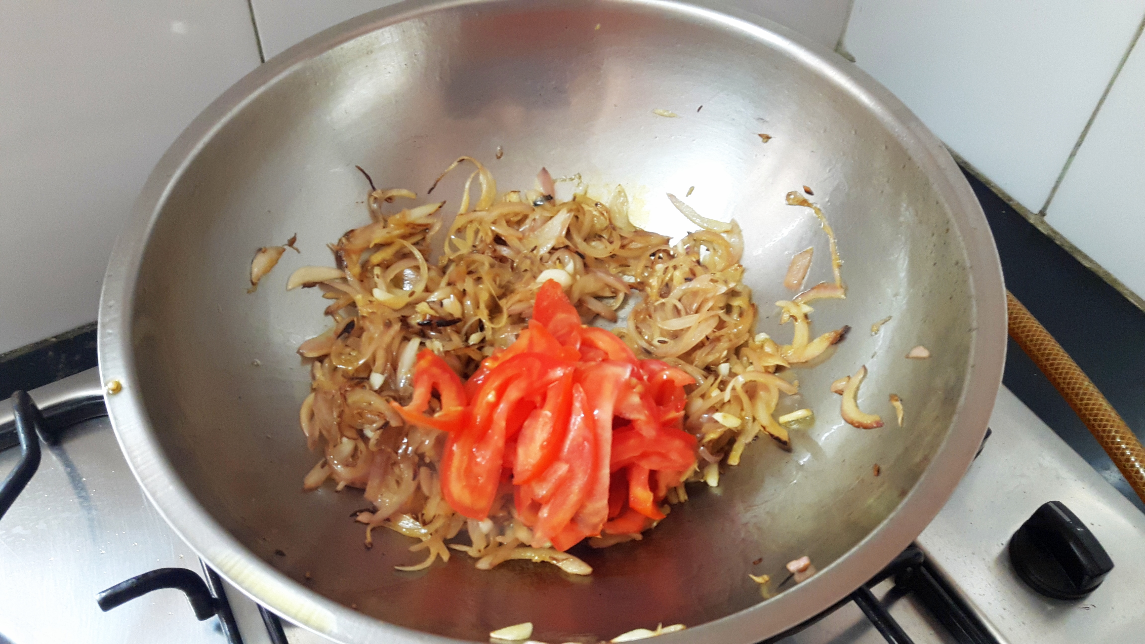 add ginger garlic and sliced tomato