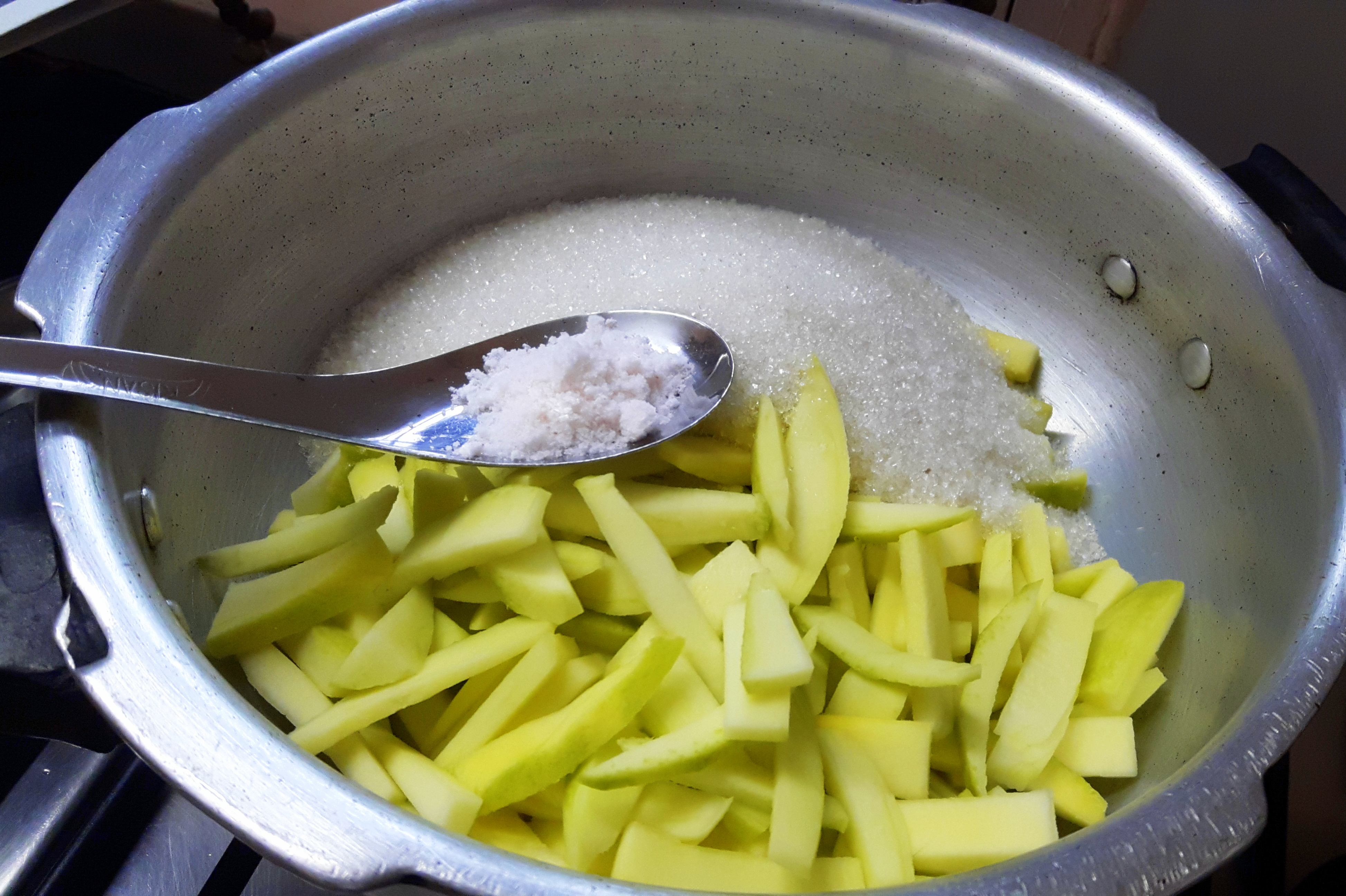raw mango pieces along with sugar and salt