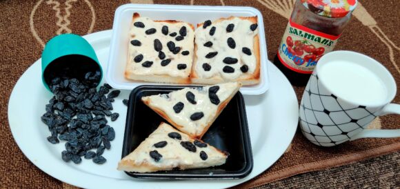 spread black raisin over the spread and again grill for a minute