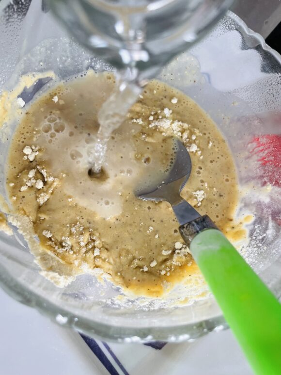 Add water slowly to avoid lumps