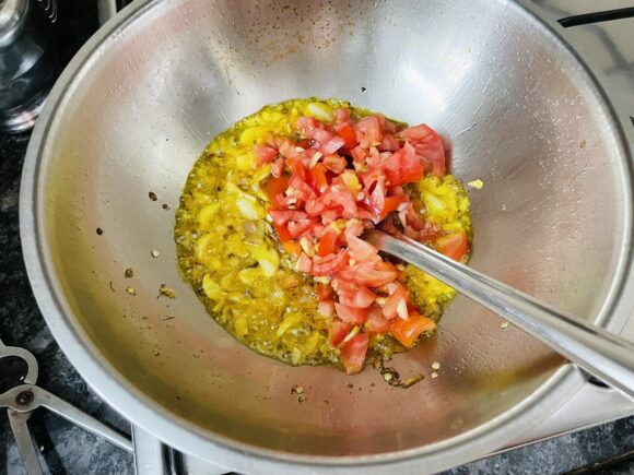 Add chopped tomatoes, coriander powder, chilli powder