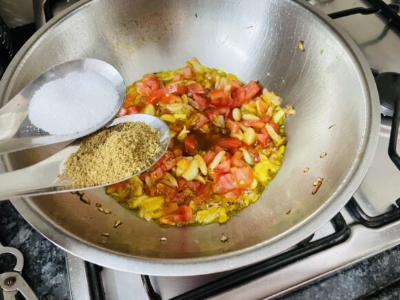 Add chopped tomatoes, coriander powder, chilli powder