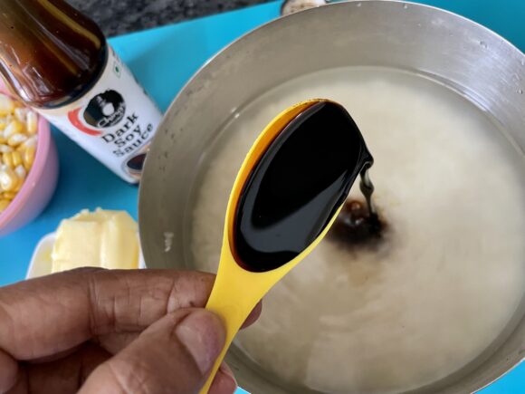 Add soya sauce and corn to soaked rice