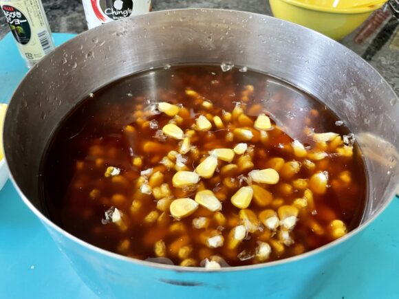 Add soya sauce and corn to soaked rice