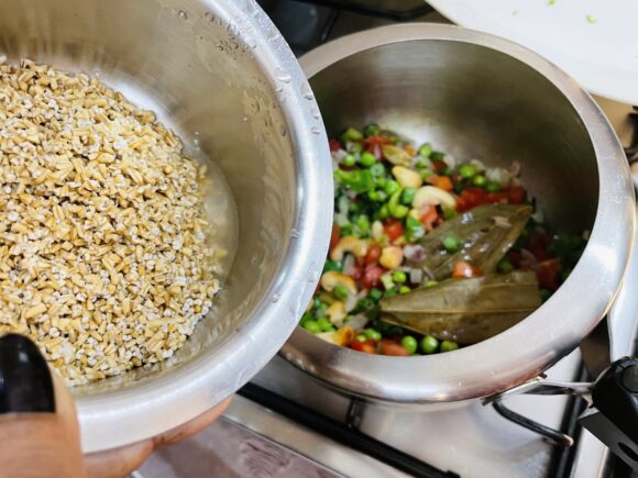 add washed steel cut oats and green chilli