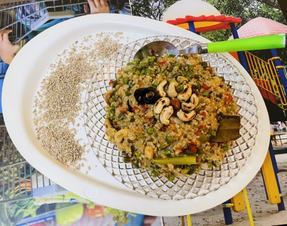 Transfer Pulao in serving plate and decorate with fries cashew nuts