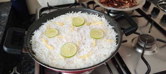 Spread cooked rice over the prepared paneer; spread ginger Julian and sliced lemon